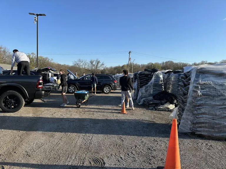 Mulch fundraiser, players loading mulch for delivery